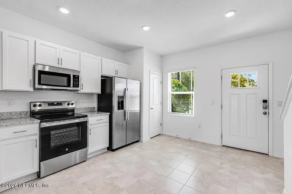 a kitchen with cabinets and stainless steel appliances