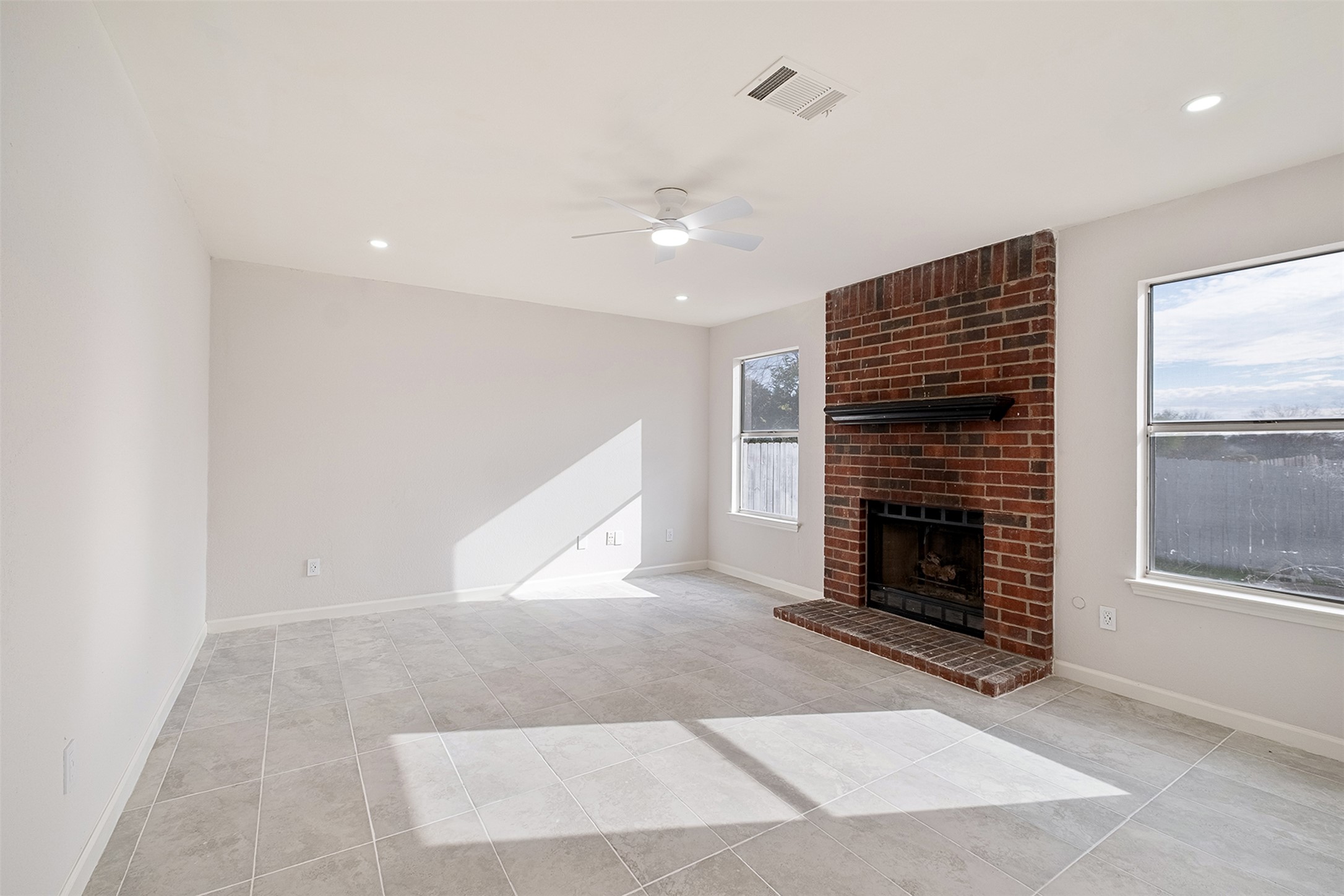 518 Tanner Trail Pflugerville, TX 78660 - Photo 11 of 32 an empty room with windows and fireplace