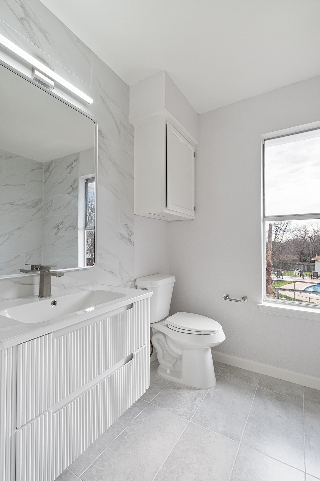 518 Tanner Trail Pflugerville, TX 78660 - Photo 19 of 32 a bathroom with a sink toilet and window