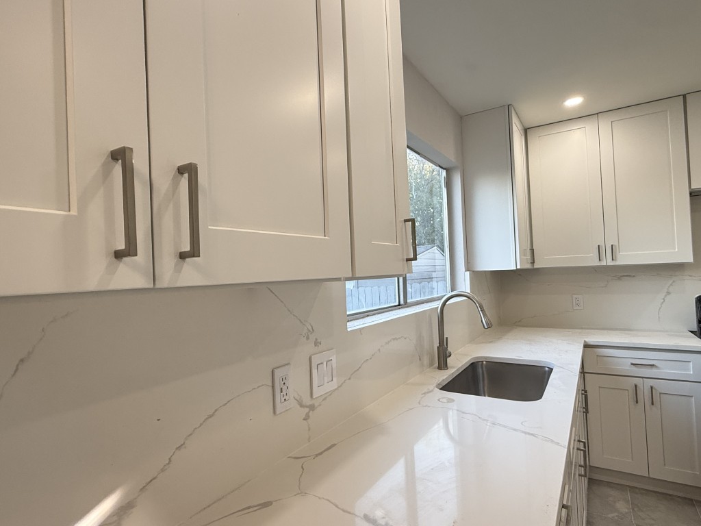 518 Tanner Trail Pflugerville, TX 78660 - Photo 2 of 7 a kitchen with a sink a stove and cabinets