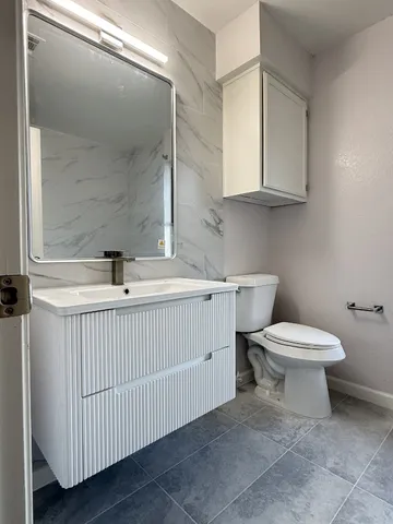 a kitchen with a sink a stove and cabinets