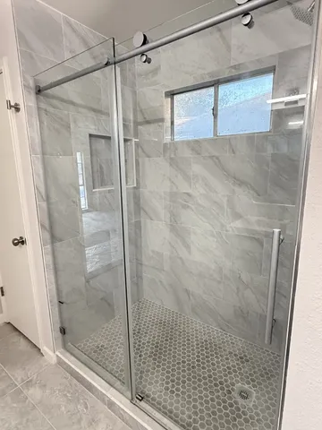 a bathroom with a shower and a sink