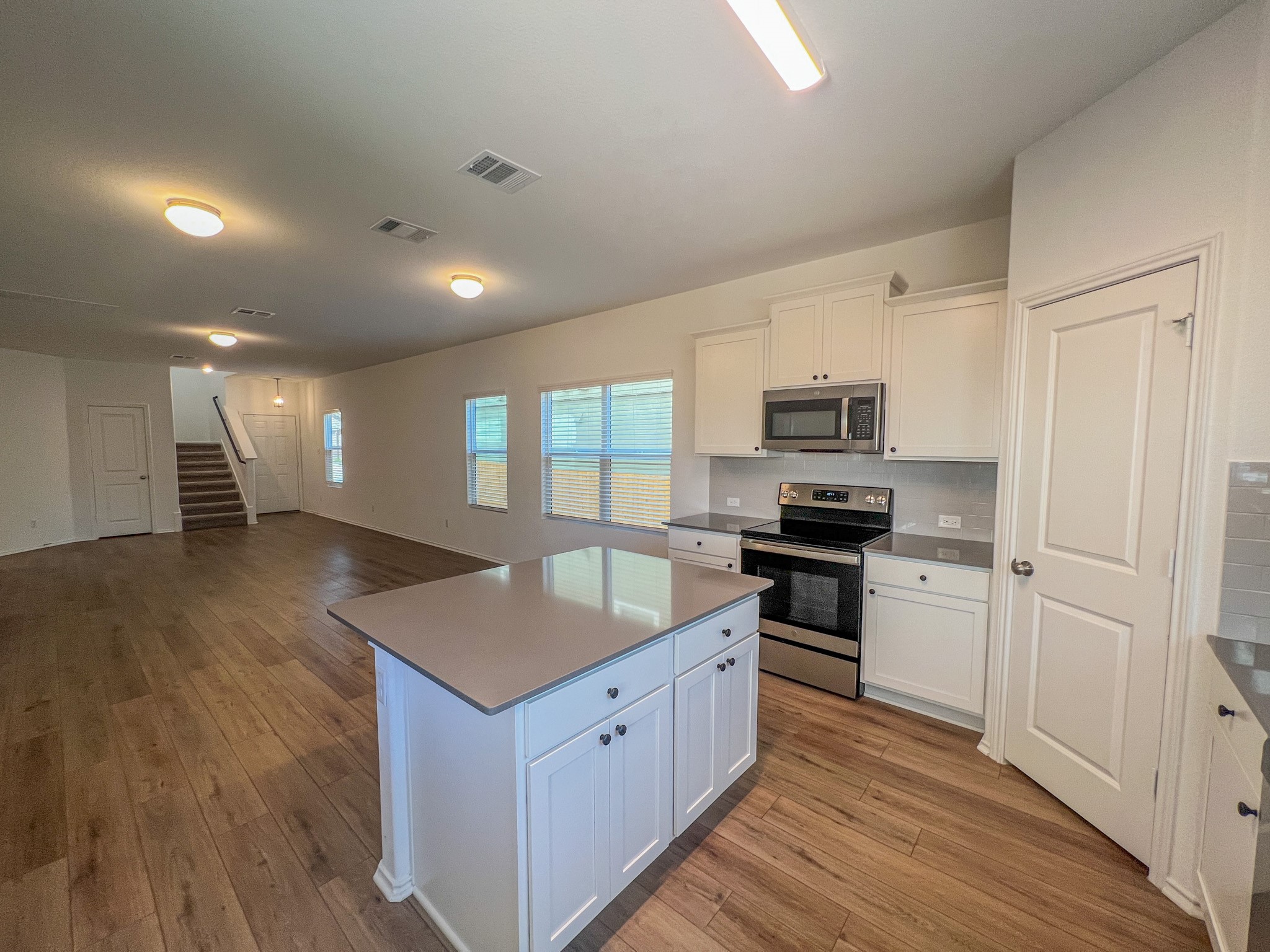 438 Perfect World Loop Jarrell, TX 76537 - Photo 6 of 35 a kitchen with stainless steel appliances granite countertop a stove a sink and a refrigerator