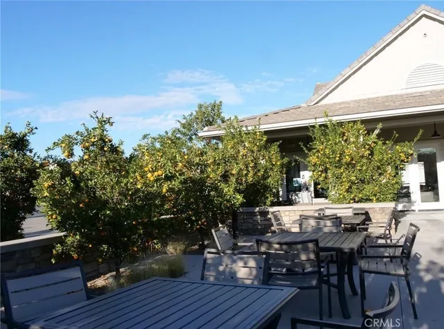 a view of a dinning table and chairs in patio of the house