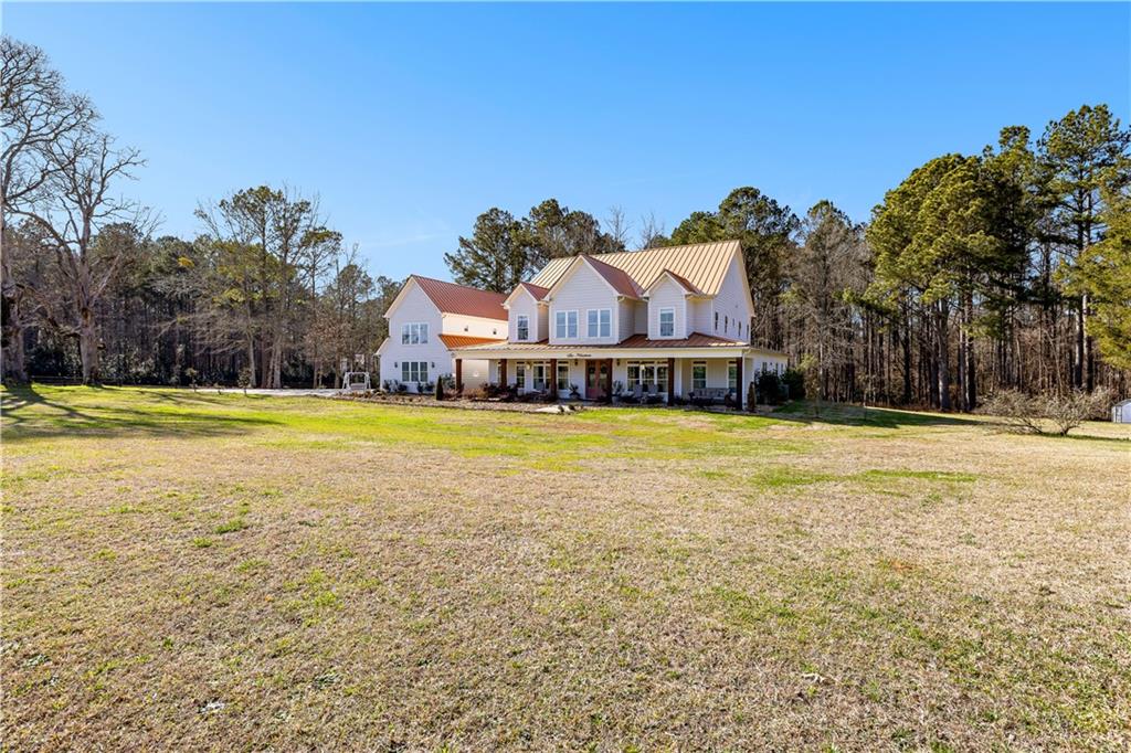 619 Old Greenville Road Fayetteville, GA 30215 - Photo 102 of 107 a view of a house with a yard