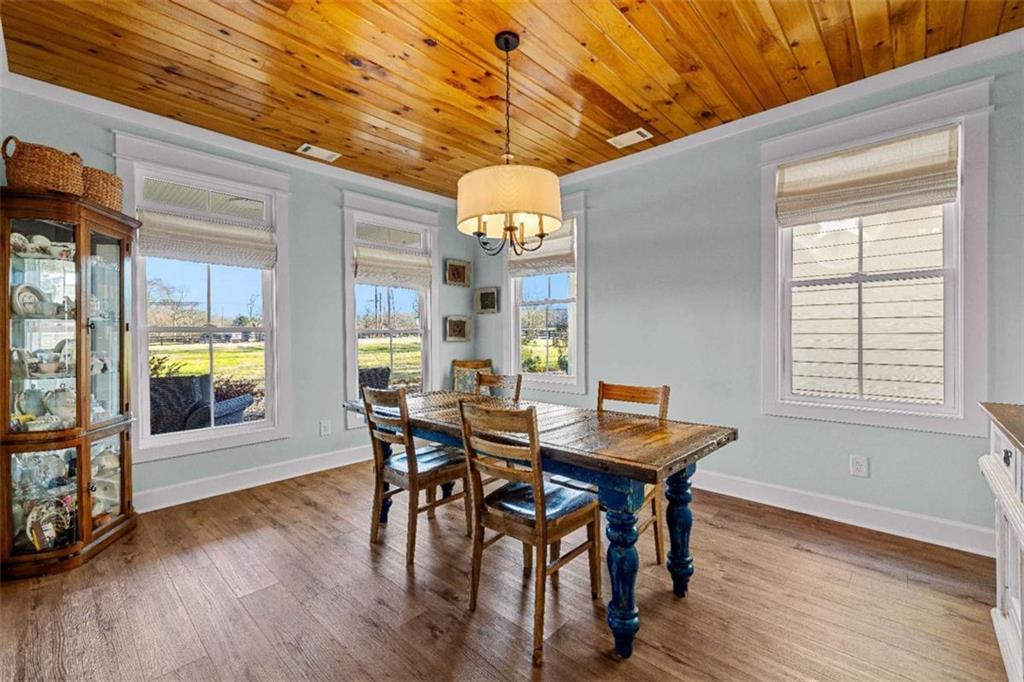 619 Old Greenville Road Fayetteville, GA 30215 - Photo 34 of 107 a view of a dining room with furniture and wooden floor