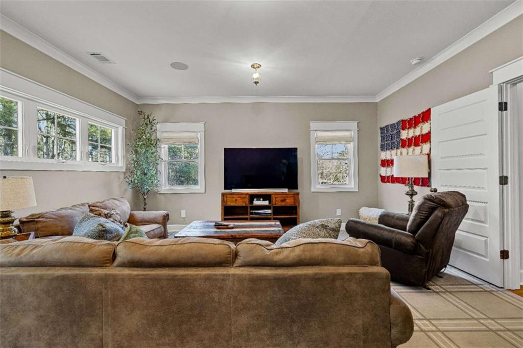 619 Old Greenville Road Fayetteville, GA 30215 - Photo 72 of 107 a living room with furniture and a flat screen tv