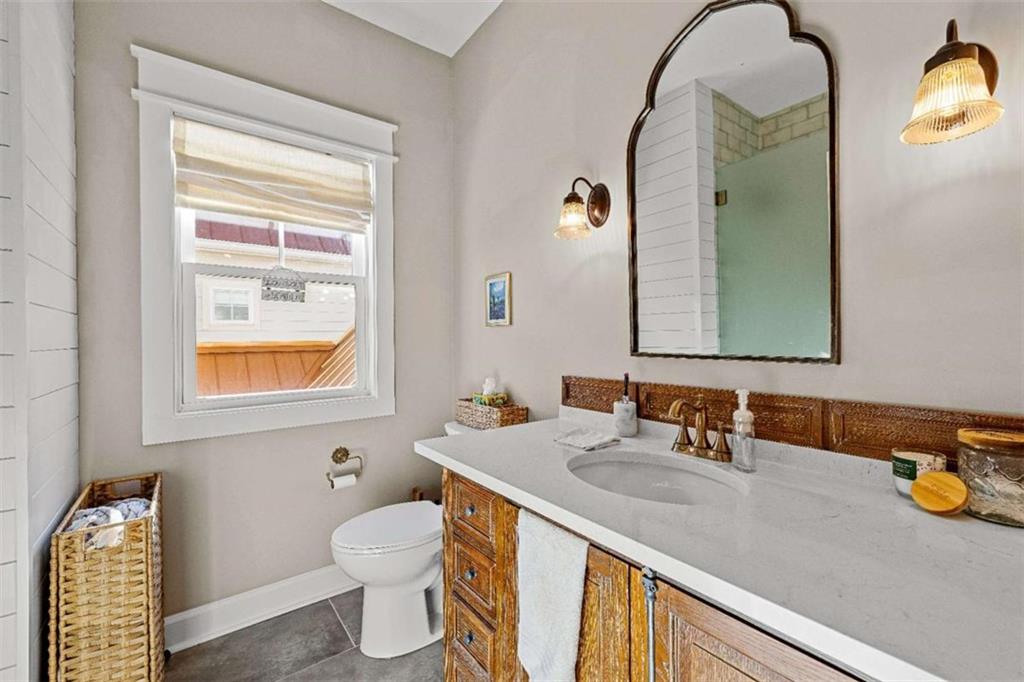 619 Old Greenville Road Fayetteville, GA 30215 - Photo 78 of 107 a bathroom with a sink a toilet and a mirror