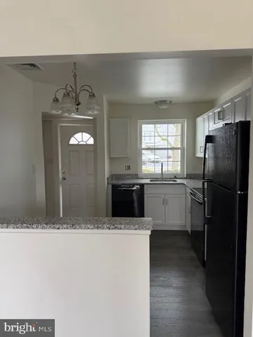 a kitchen with a refrigerator and a sink