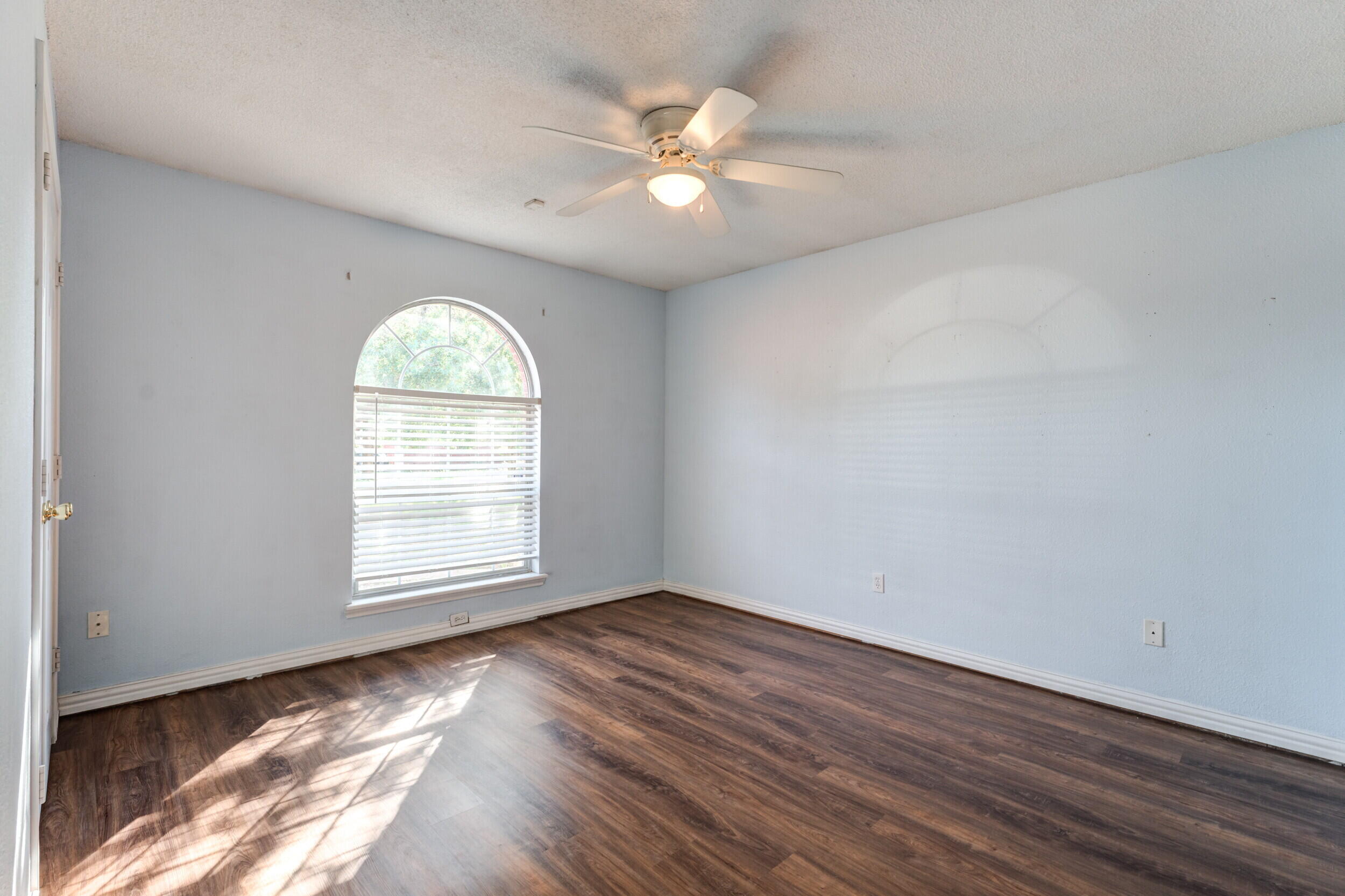 6325 14th Street Lubbock, TX 79416 - Photo 17 of 28 an empty room with wooden floor and windows