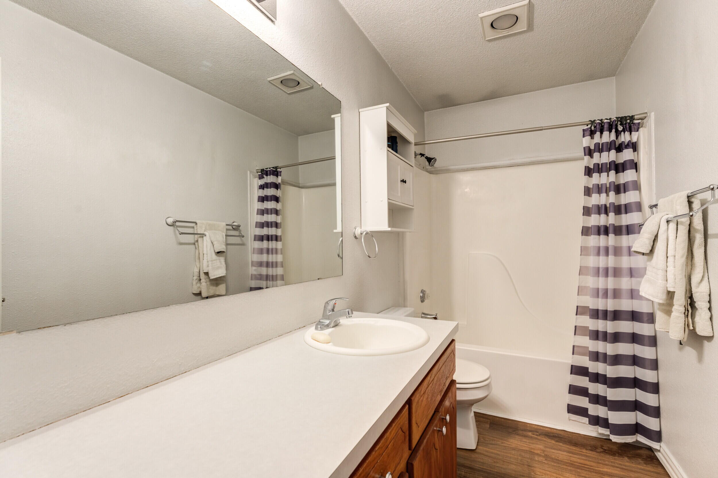 6325 14th Street Lubbock, TX 79416 - Photo 22 of 28 a bathroom with a sink and a mirror