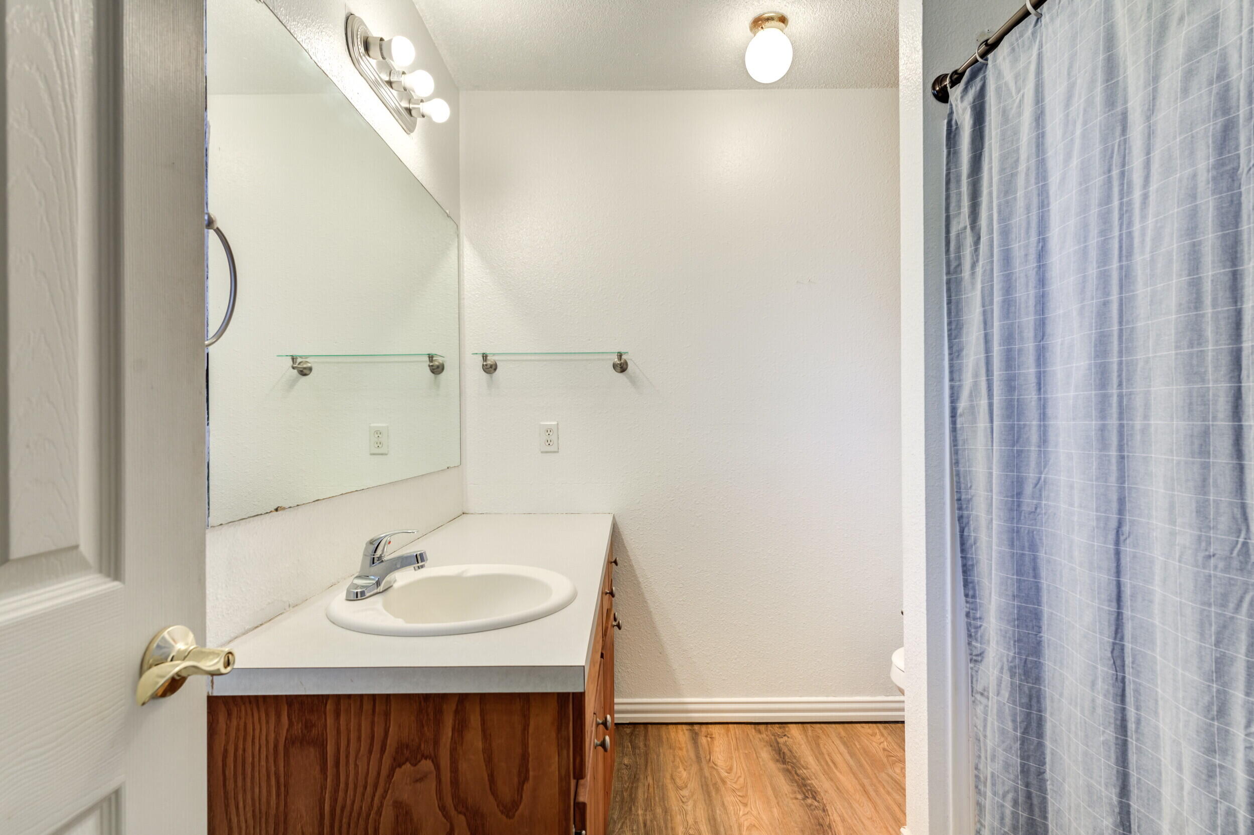 6325 14th Street Lubbock, TX 79416 - Photo 23 of 28 a bathroom with a sink and a mirror