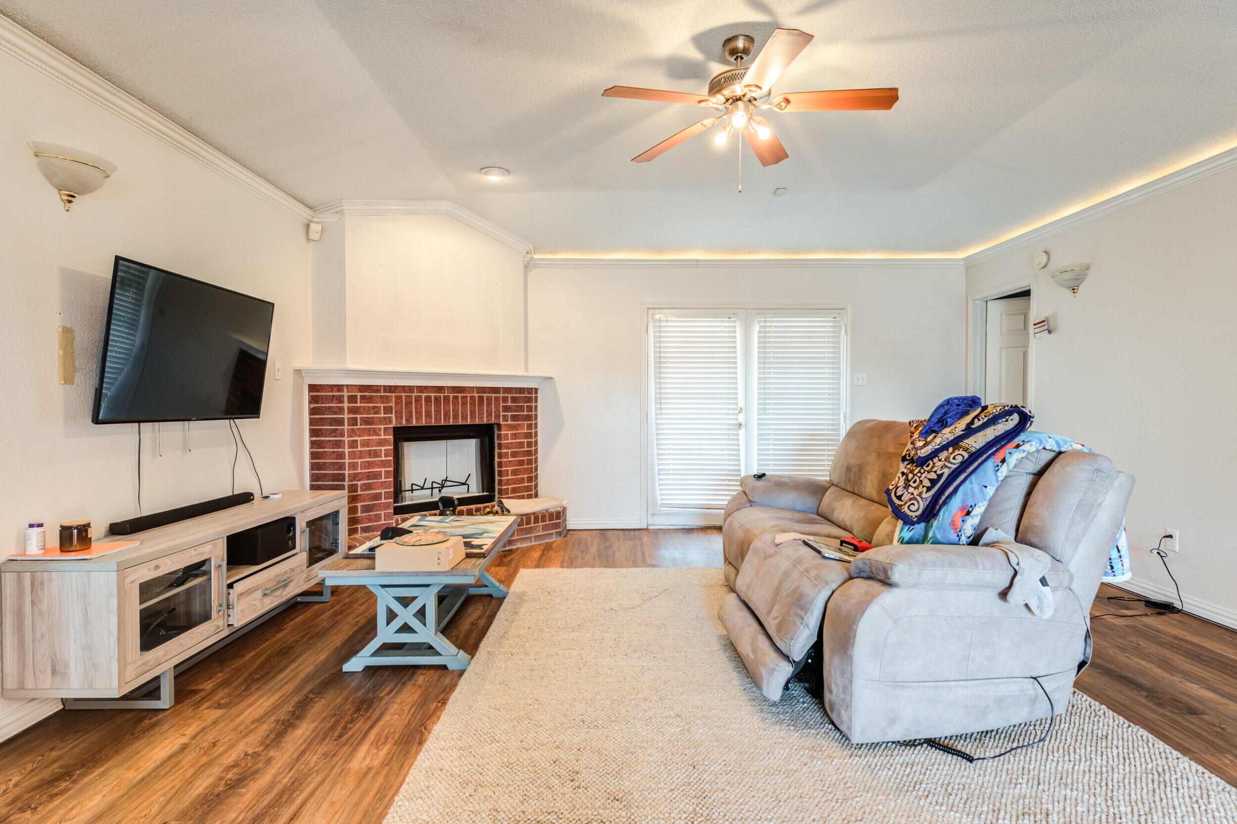 6325 14th Street Lubbock, TX 79416 - Photo 4 of 28 a living room with furniture and a flat screen tv
