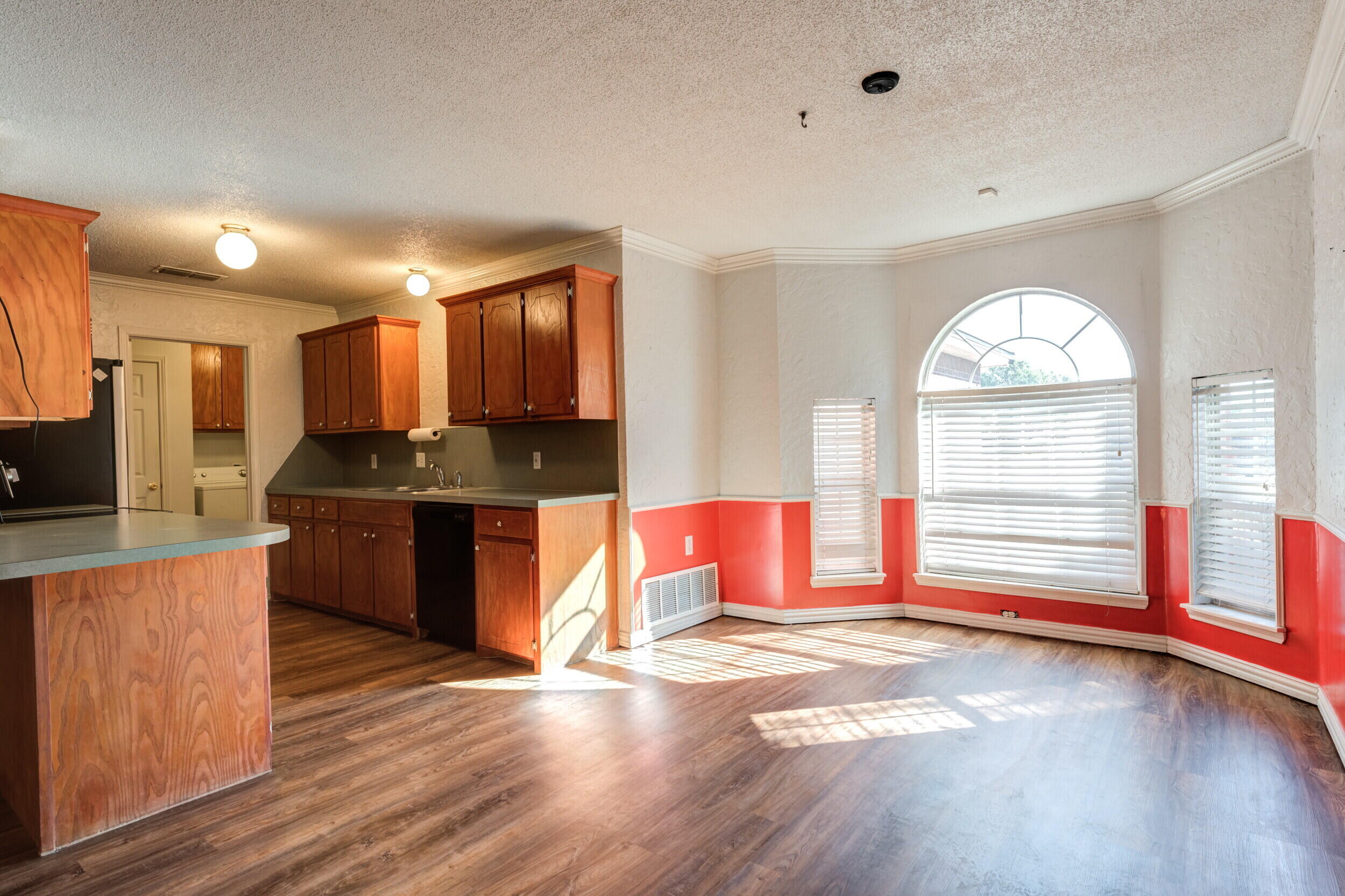 6325 14th Street Lubbock, TX 79416 - Photo 7 of 28 a kitchen with stainless steel appliances granite countertop a stove a sink and a refrigerator
