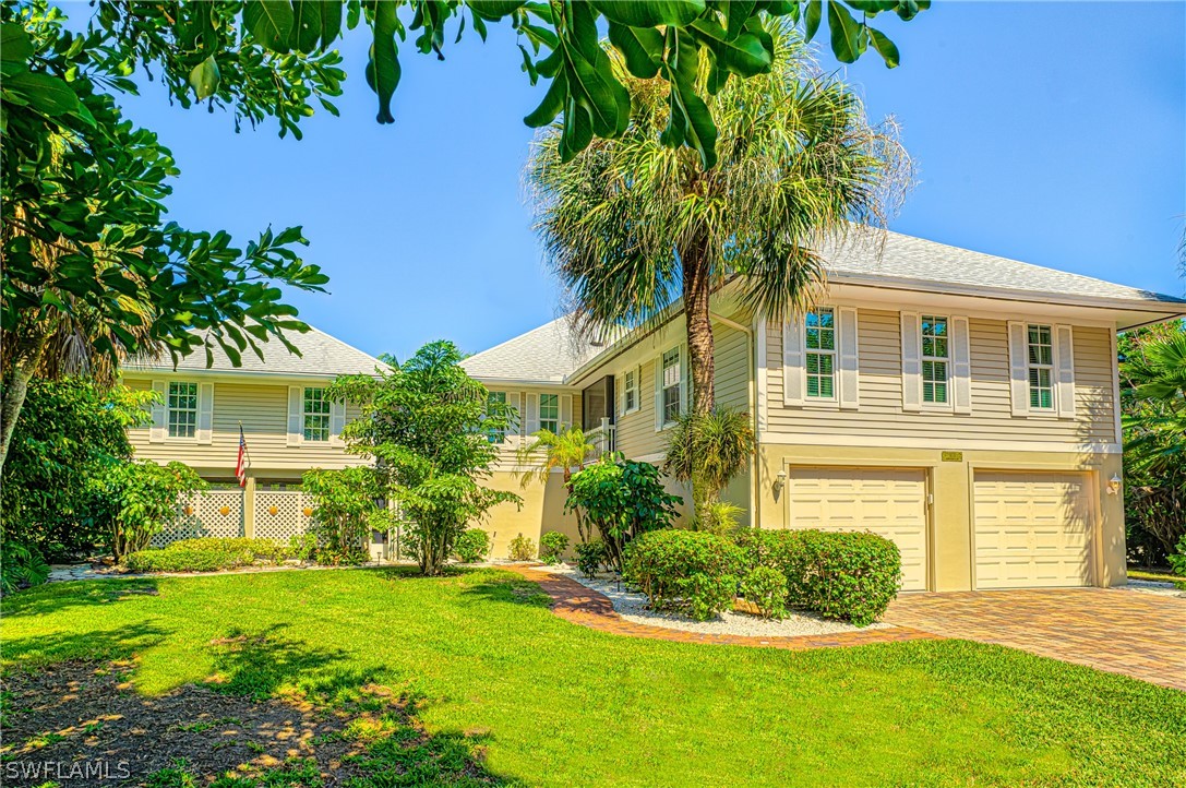 1031 Sand Castle Road Sanibel, FL 33957 - Photo 1 of 27 front view of a house with a yard