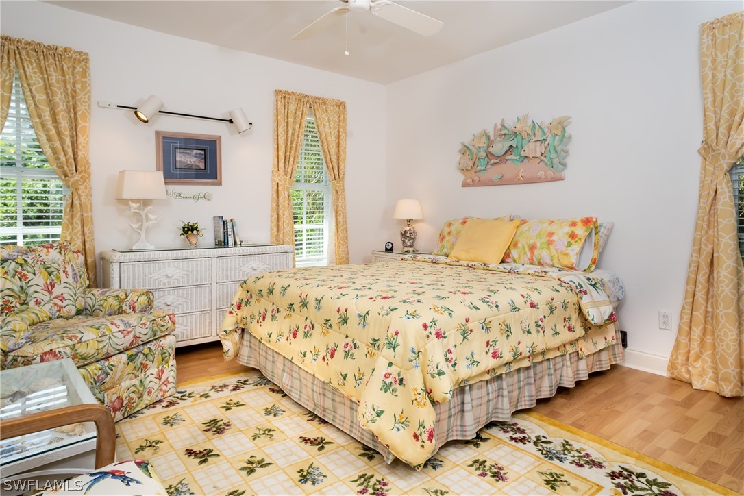 1031 Sand Castle Road Sanibel, FL 33957 - Photo 16 of 27 a bedroom with a bed and wooden floor