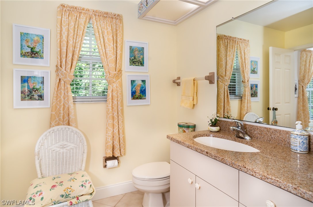 1031 Sand Castle Road Sanibel, FL 33957 - Photo 17 of 27 a bathroom with a granite countertop sink a large mirror and a shower