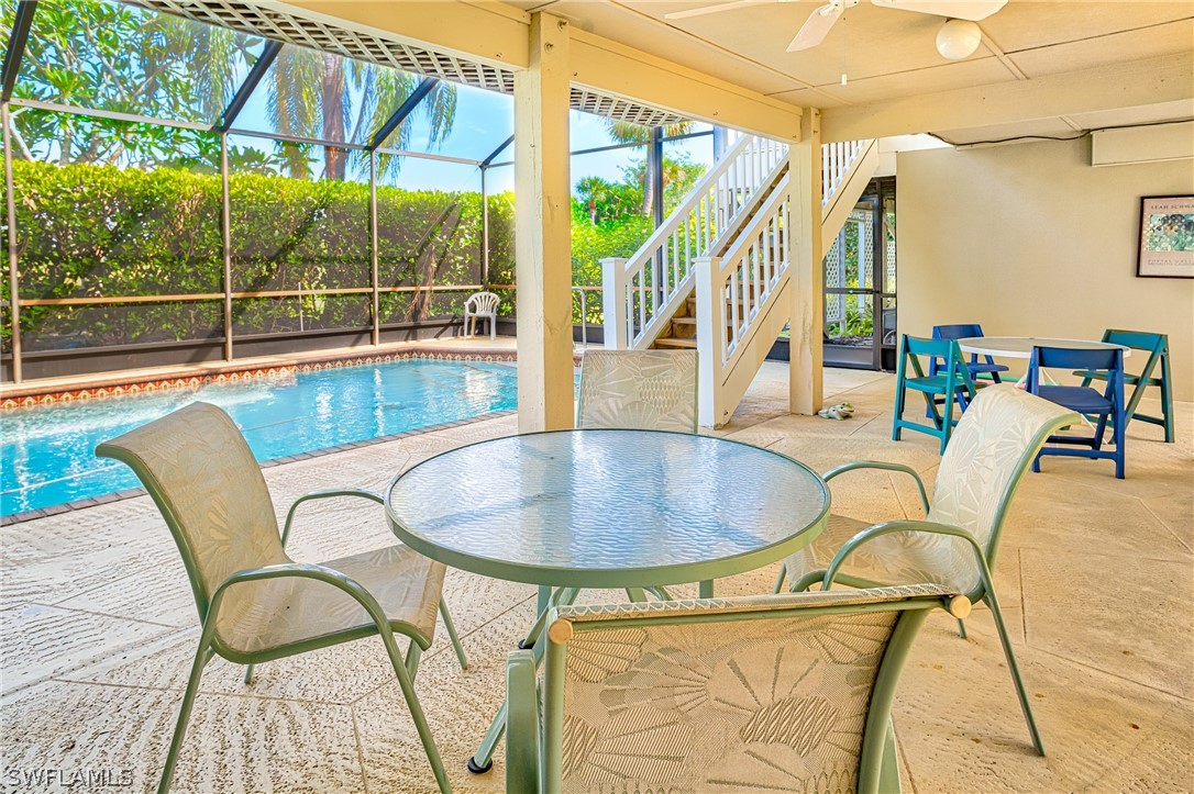 1031 Sand Castle Road Sanibel, FL 33957 - Photo 19 of 27 a dining room with furniture and wooden floor