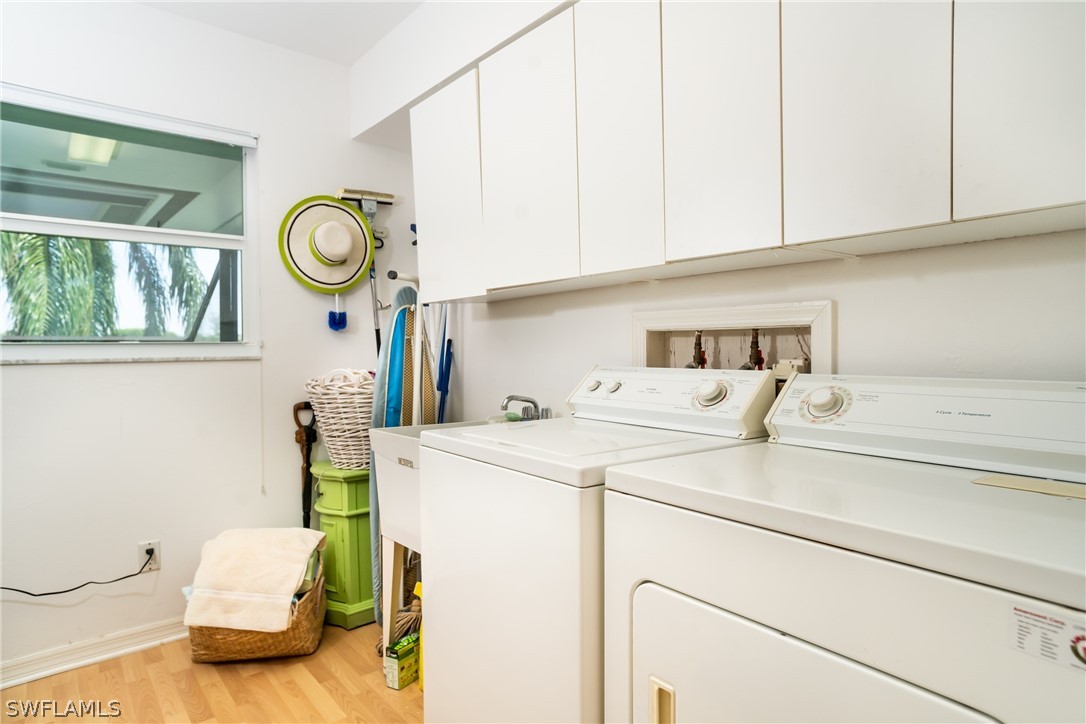 1031 Sand Castle Road Sanibel, FL 33957 - Photo 22 of 27 a utility room with a sink dryer and washer