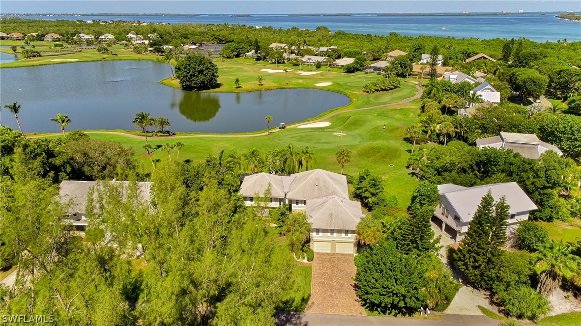 1031 Sand Castle Road Sanibel, FL 33957 - Photo 24 of 27 a view of a swimming pool with a yard