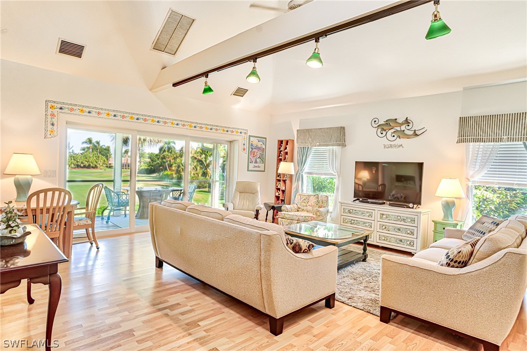 1031 Sand Castle Road Sanibel, FL 33957 - Photo 5 of 27 a living room with furniture flat screen tv and a large window