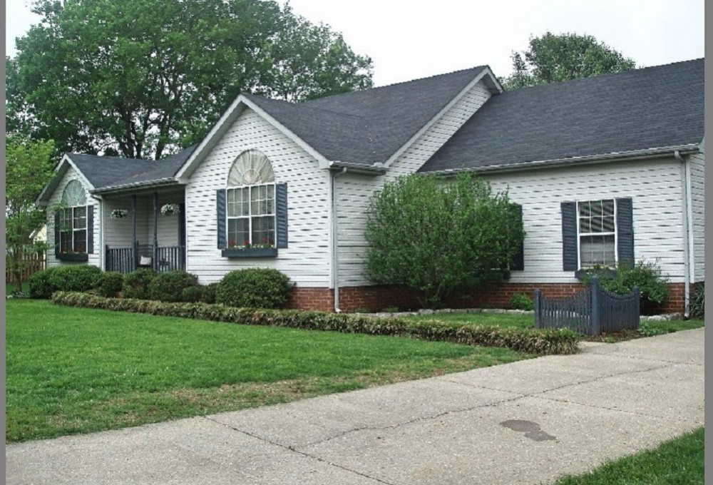 a front view of a house with a yard