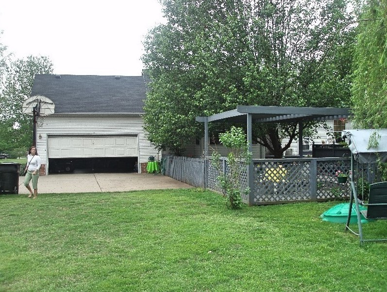 2306 Riverstone Drive Murfreesboro, TN 37128 - Photo 17 of 18 a view of a house with a yard and a garden