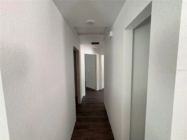 a view of a hallway with a wooden floor