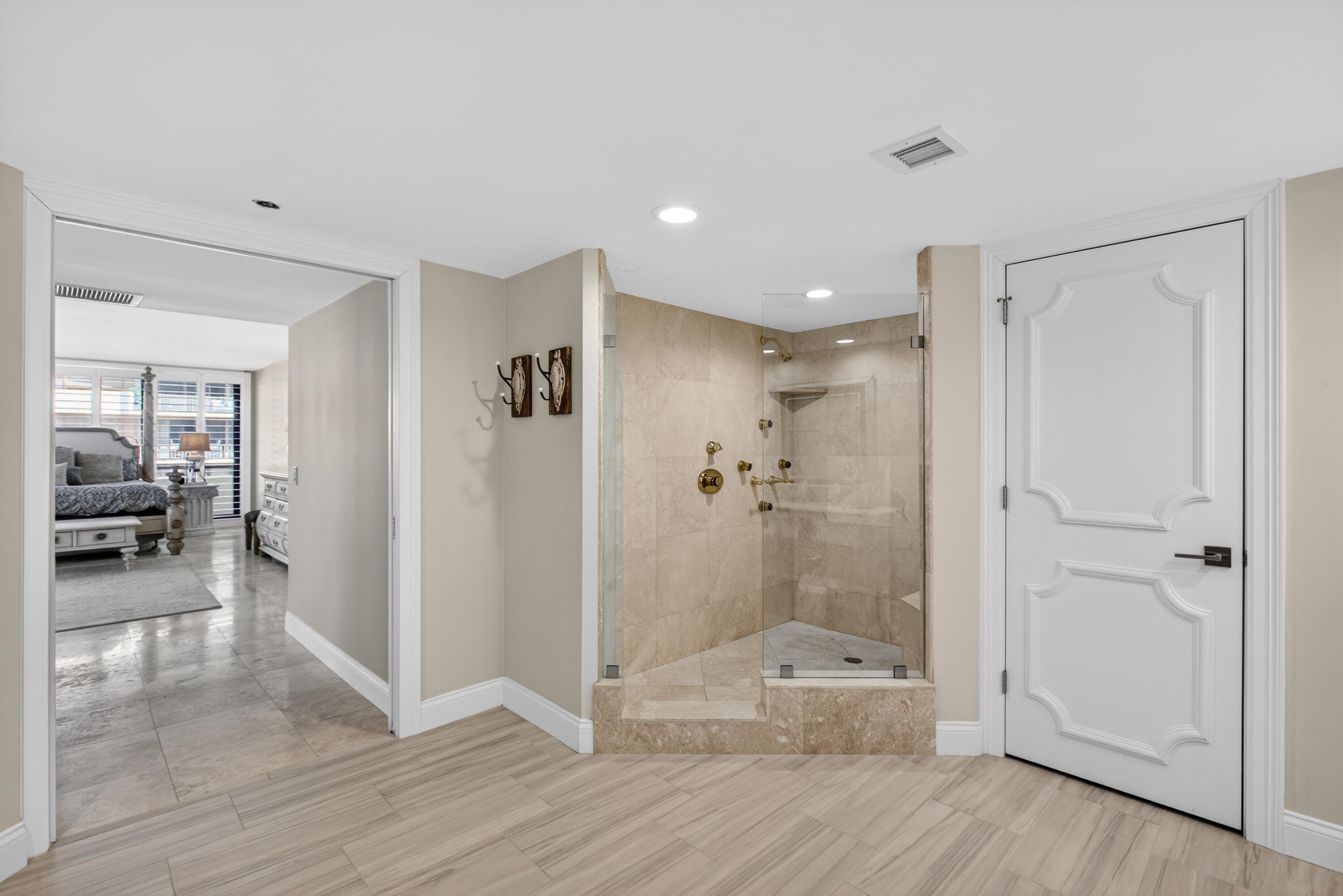 4050 North Ocean Drive, Unit 301 Riviera Beach, FL 33404 - Photo 27 of 62 a bathroom with a glass shower door a sink and a mirror