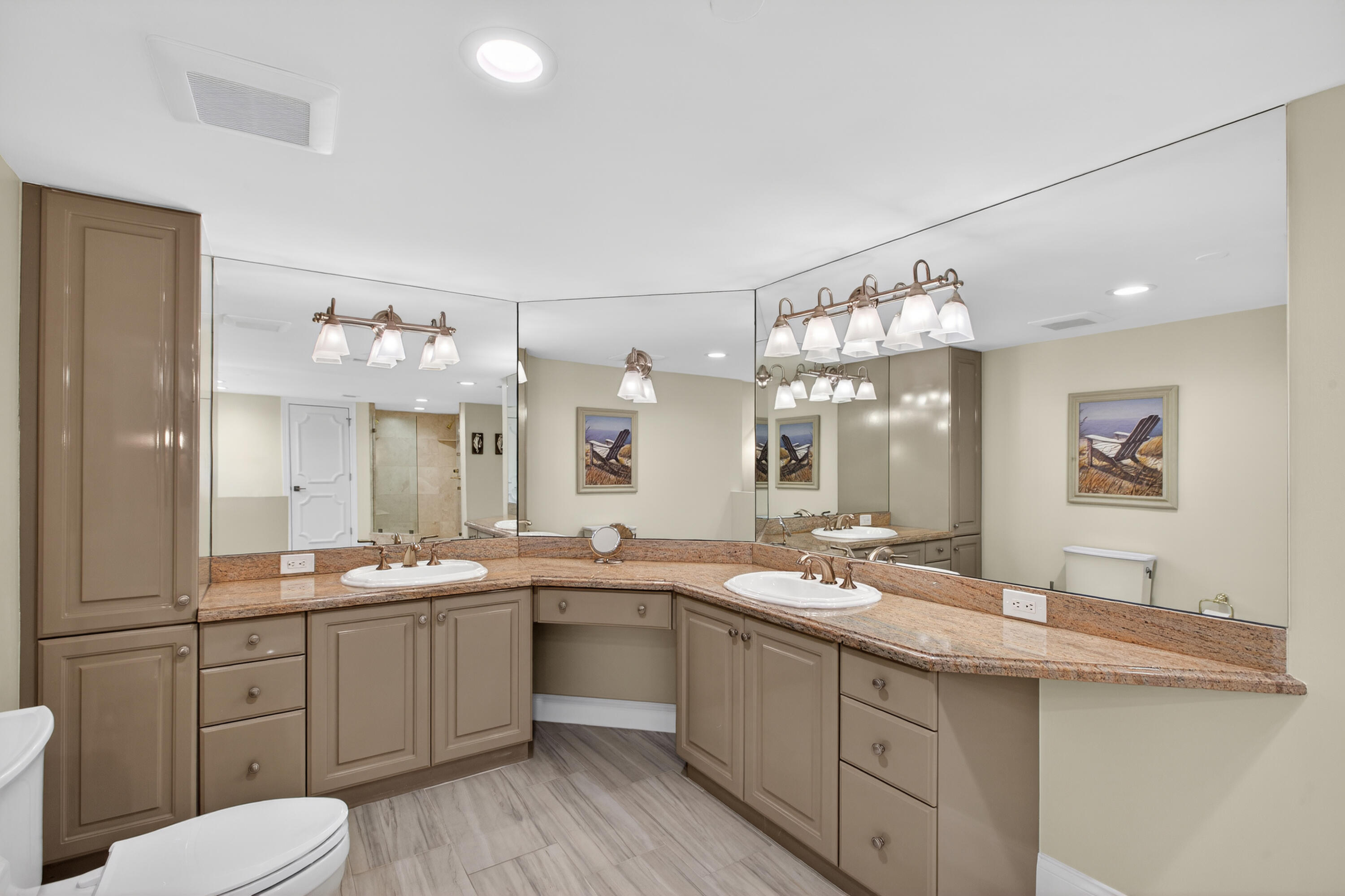 4050 North Ocean Drive, Unit 301 Riviera Beach, FL 33404 - Photo 28 of 62 a large bathroom with a double vanity sink mirror and toilet