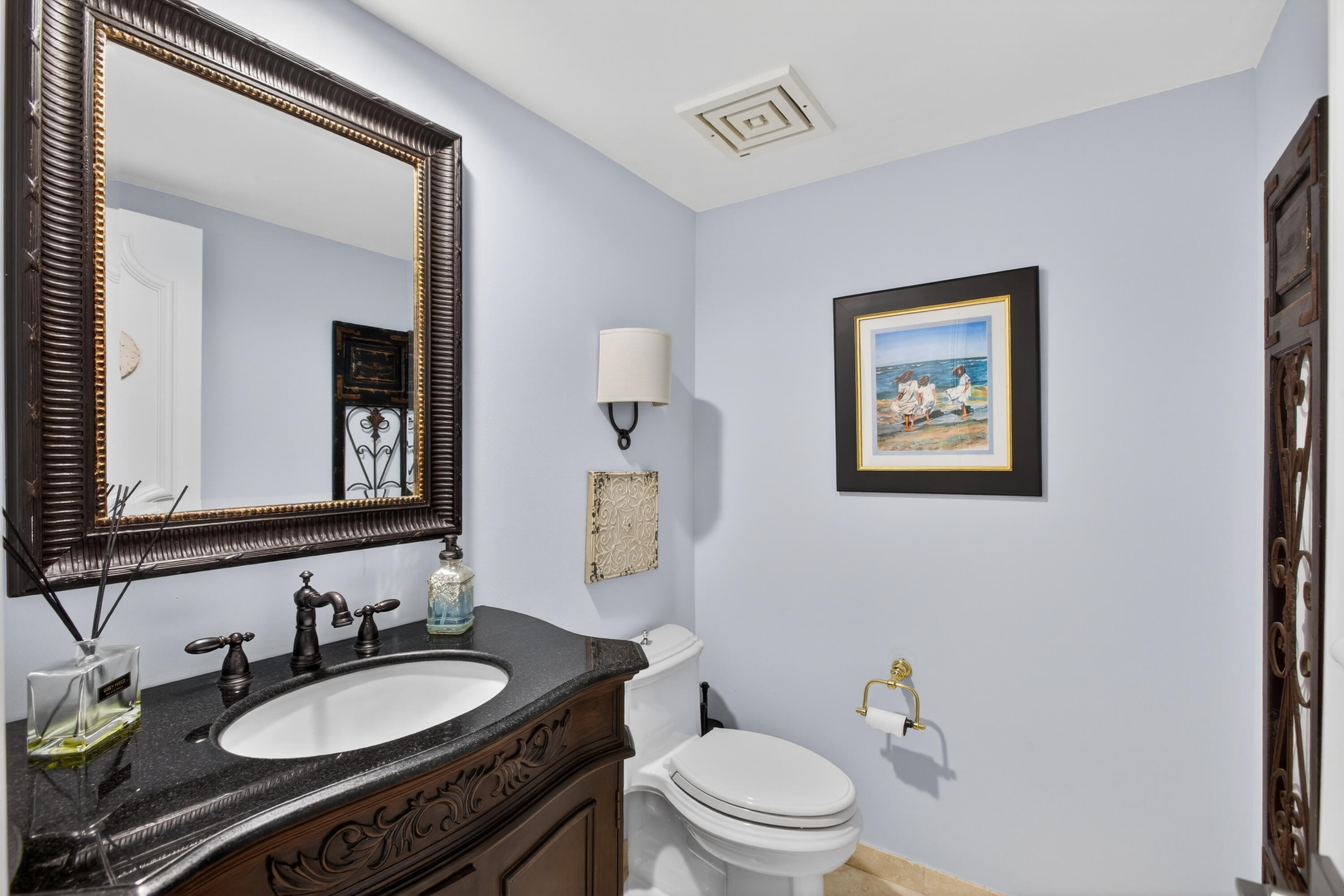 4050 North Ocean Drive, Unit 301 Riviera Beach, FL 33404 - Photo 33 of 62 a bathroom with a granite countertop toilet a sink and mirror