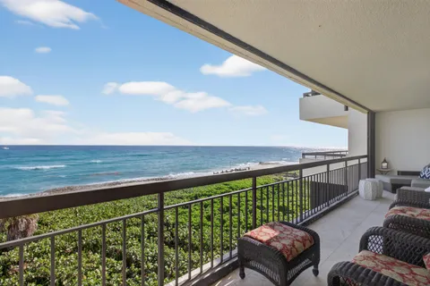 a living room with furniture a fireplace and a chandelier