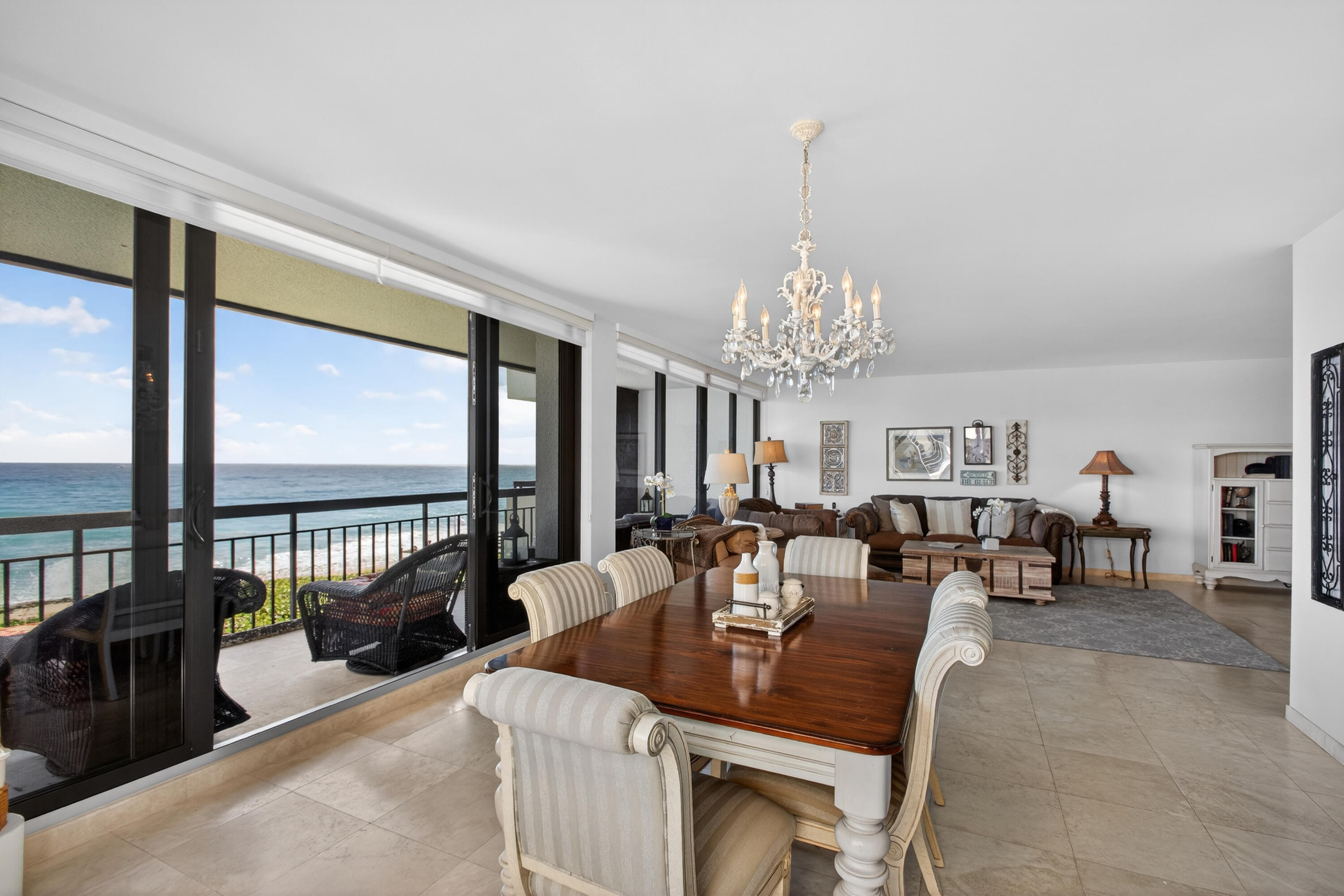 4050 North Ocean Drive, Unit 301 Riviera Beach, FL 33404 - Photo 7 of 62 a living room with furniture a chandelier and a chandelier