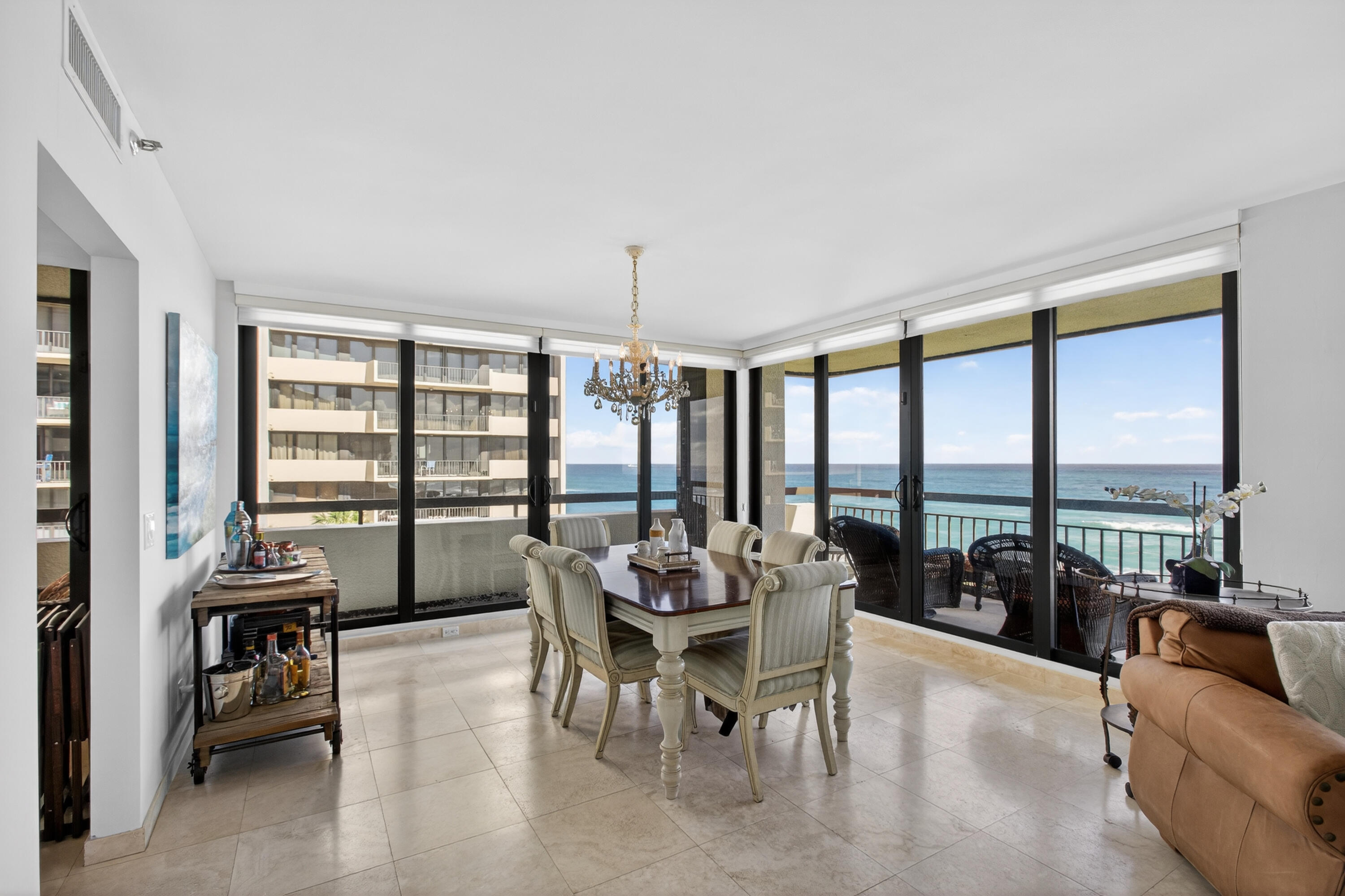 4050 North Ocean Drive, Unit 301 Riviera Beach, FL 33404 - Photo 8 of 62 a dining room with furniture and floor to ceiling windows