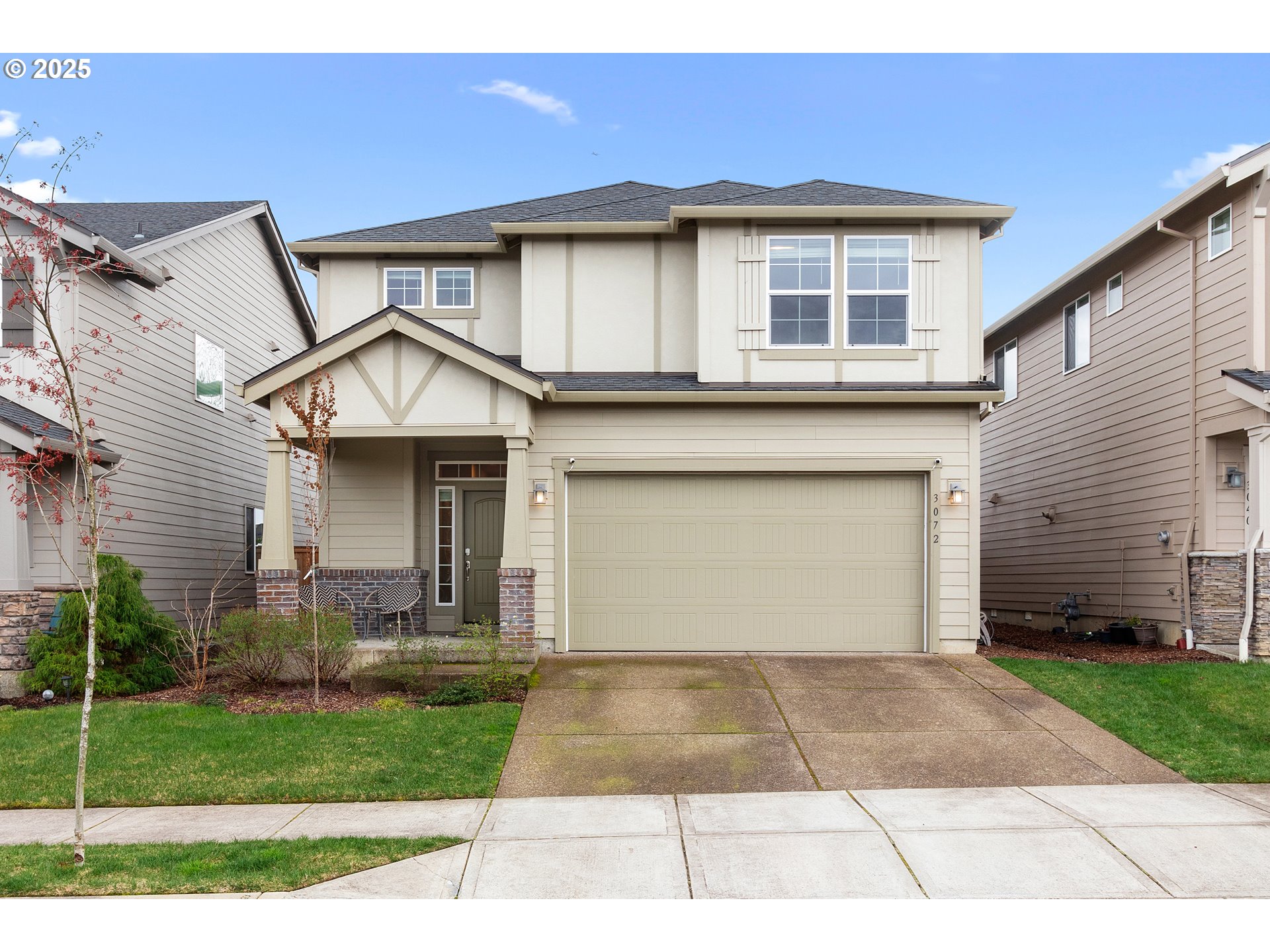 a front view of a house with a yard and a garage