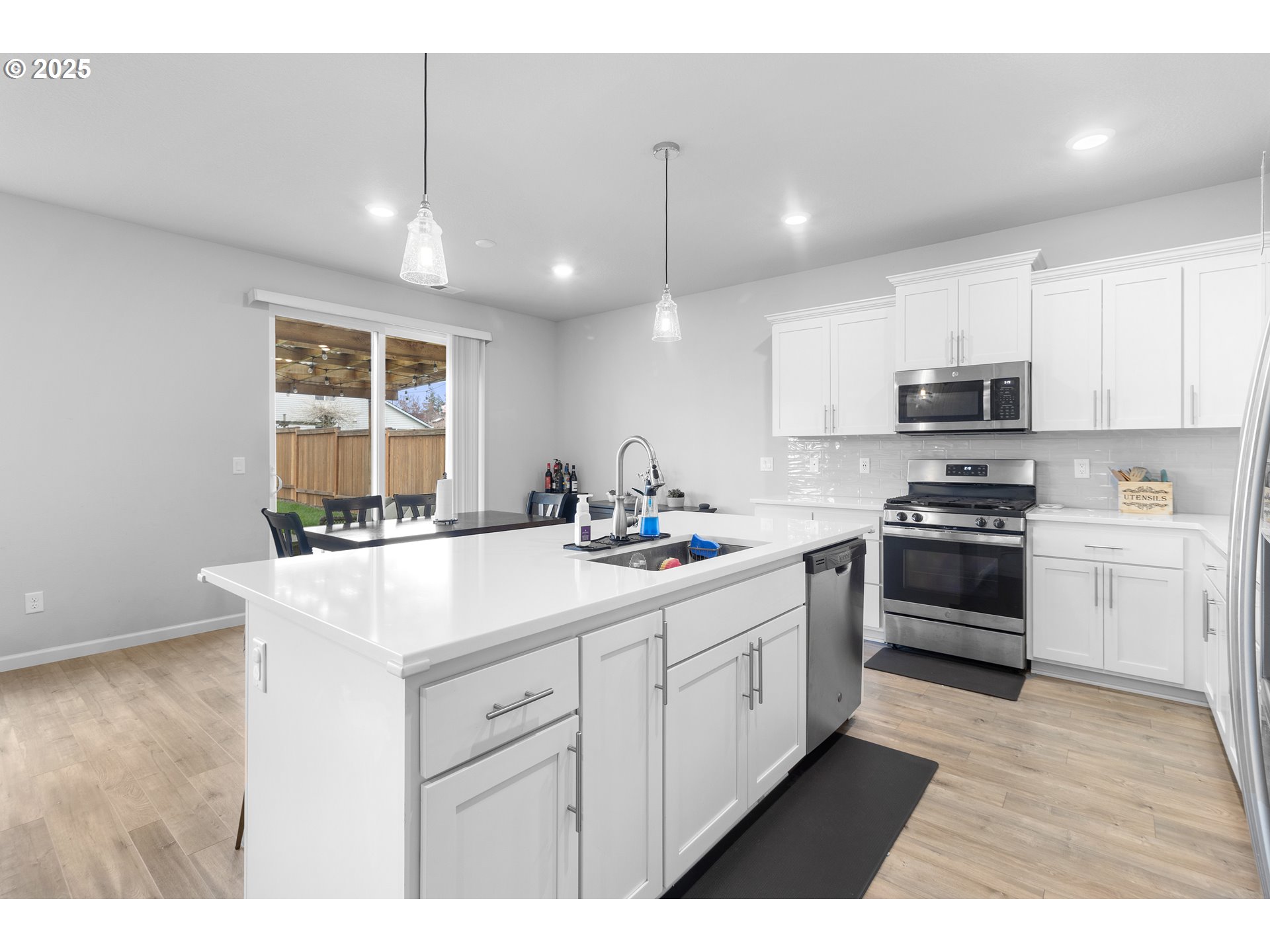 3072 Southeast 25th Street Gresham, OR 97080 - Photo 13 of 48 a kitchen with stainless steel appliances kitchen island granite countertop a sink and a stove
