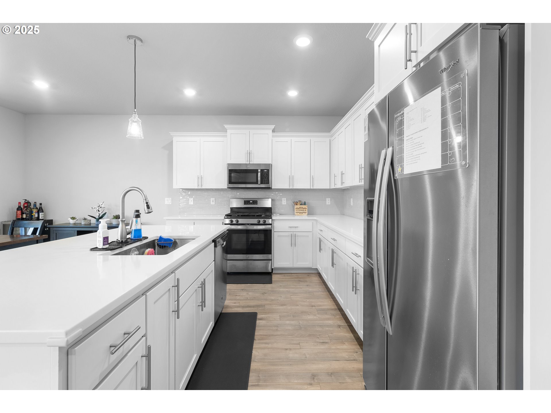 3072 Southeast 25th Street Gresham, OR 97080 - Photo 14 of 48 a kitchen with kitchen island a sink stainless steel appliances and cabinets