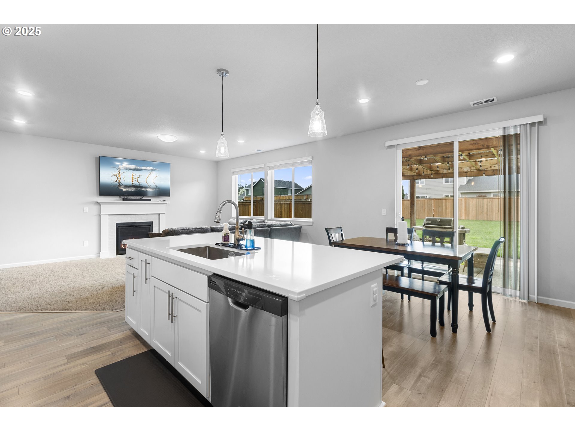 3072 Southeast 25th Street Gresham, OR 97080 - Photo 15 of 48 a kitchen with center island a sink stove and wooden floor