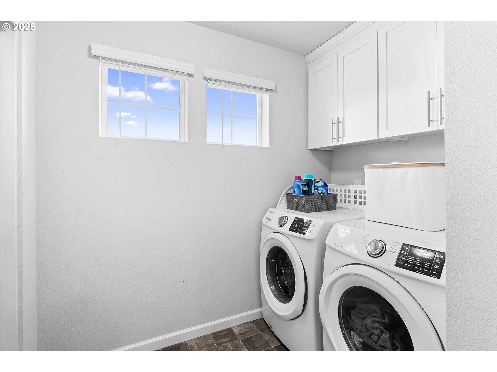 3072 Southeast 25th Street Gresham, OR 97080 - Photo 43 of 48 a view of washer and dryer with kitchen in the background