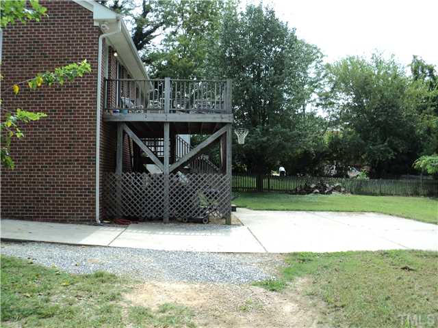 1003 Benjamin Street Raleigh, NC 27604 - Photo 3 of 8 a view of backyard with wooden fence and trees