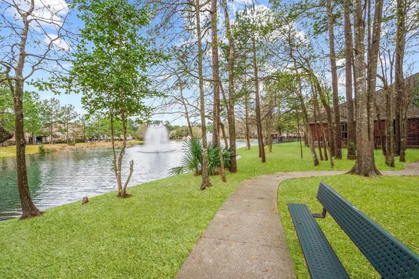 a front view of a house with a yard and lake view