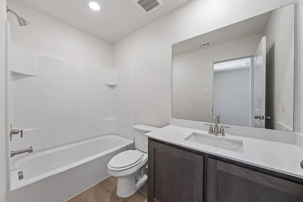 a bathroom with a sink a toilet and bathtub