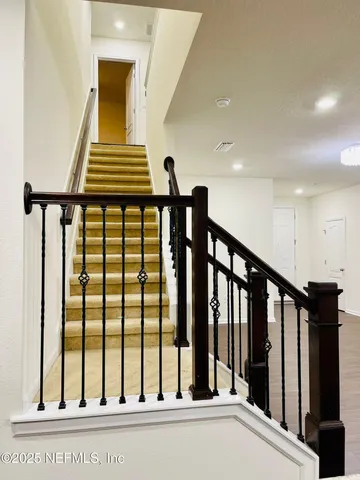 a view of staircase with black floor to ceiling window