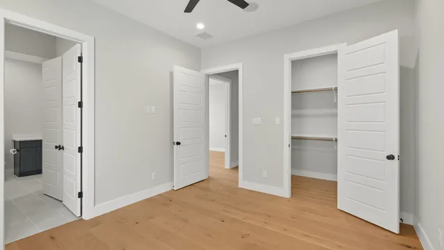 a view of empty room with wooden floor