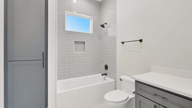 a bathroom with a toilet a sink and bathtub