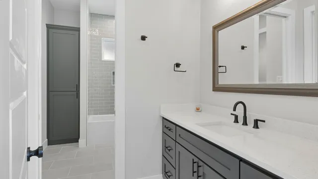 a bathroom with a sink and mirror