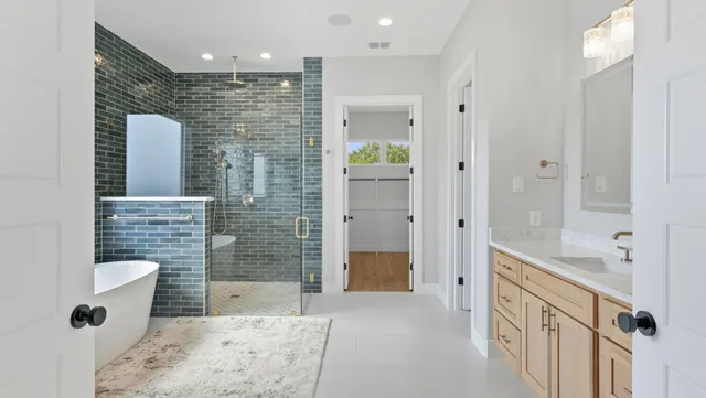 a bathroom with a granite countertop sink a toilet and shower