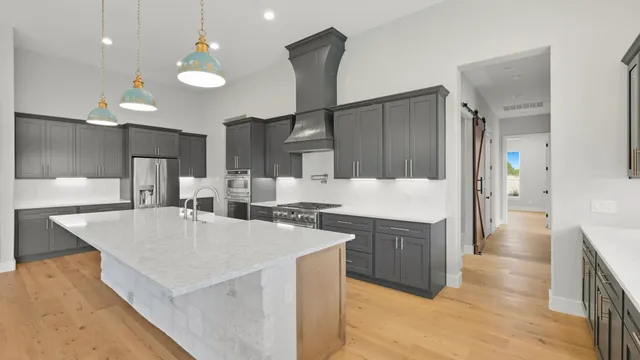 a large kitchen with cabinets and a stainless steel appliances