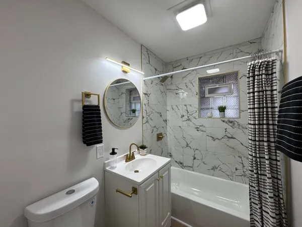 a bathroom with a toilet a sink and a bathtub