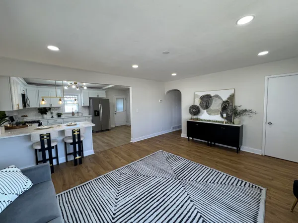 a living room with furniture a kitchen view and kitchen view